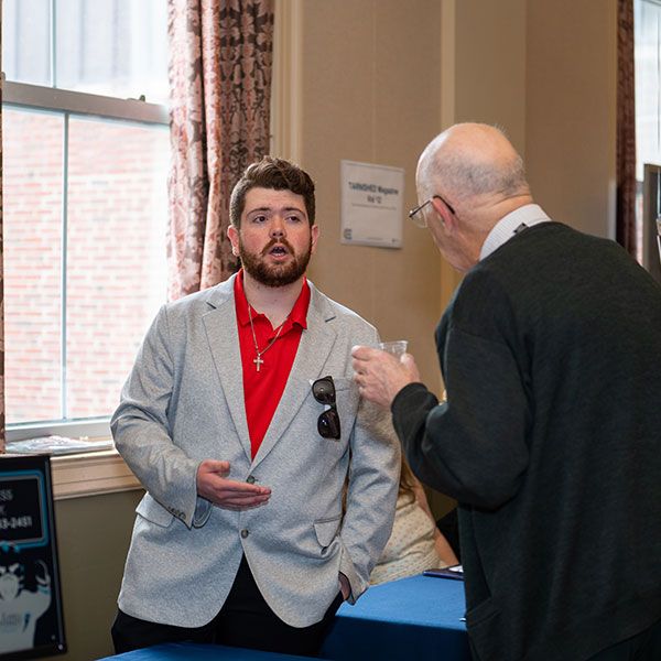 student presenting to a man