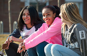 three girls sitting three girls sitting on curb